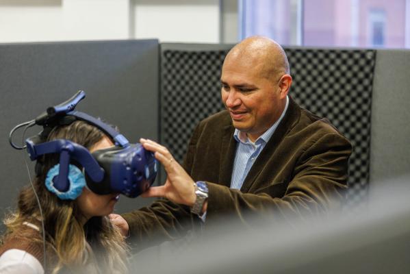 S Alvarez with student using VR headset